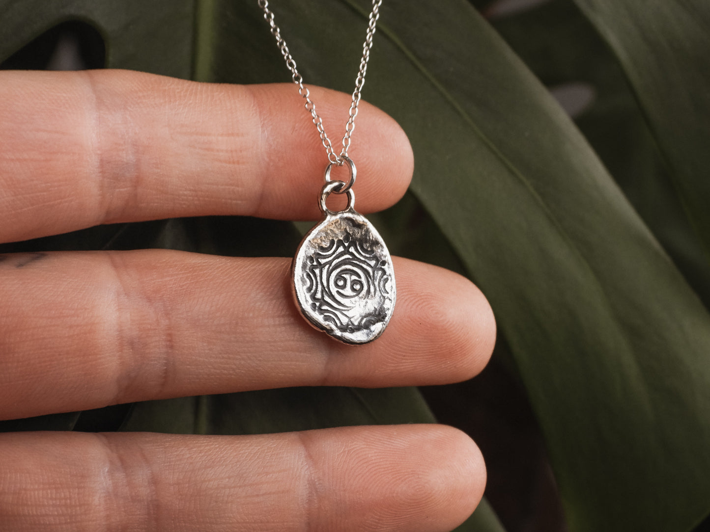 cancer star sign mandala pendant on a dainty silver chain