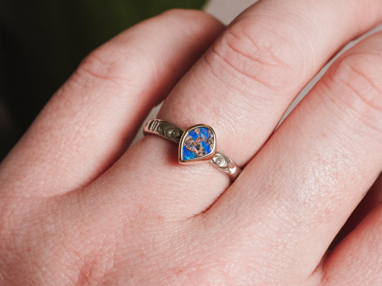 wearing a boho style australian boulder opal ring