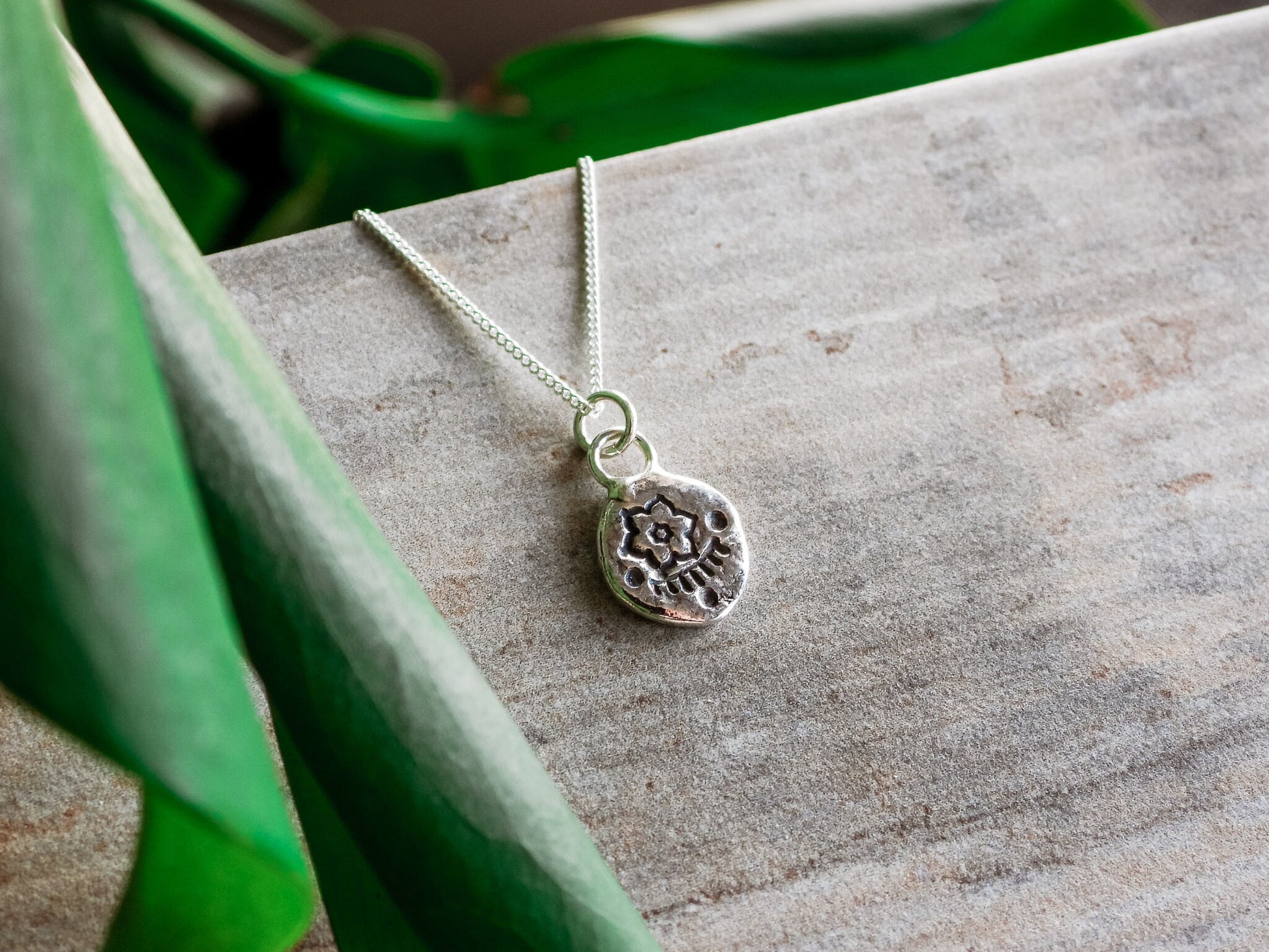 rustic flower charm necklace in a dainty and minimalist style 